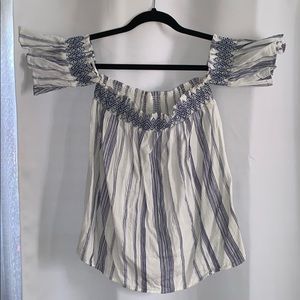 Blue and white off the shoulder patterned blouse.